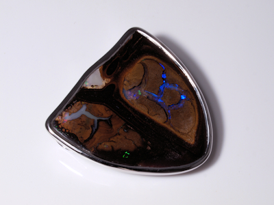 Custom silver jewelry creation with a vibrant Australian boulder opal