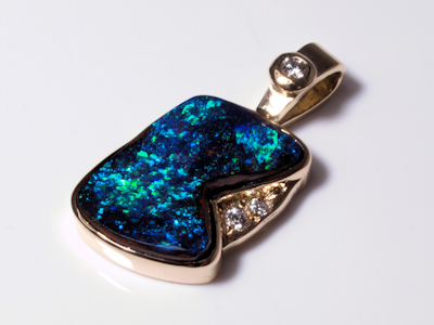 Luxury gold necklace pendant featuring a solid black opal gemstone