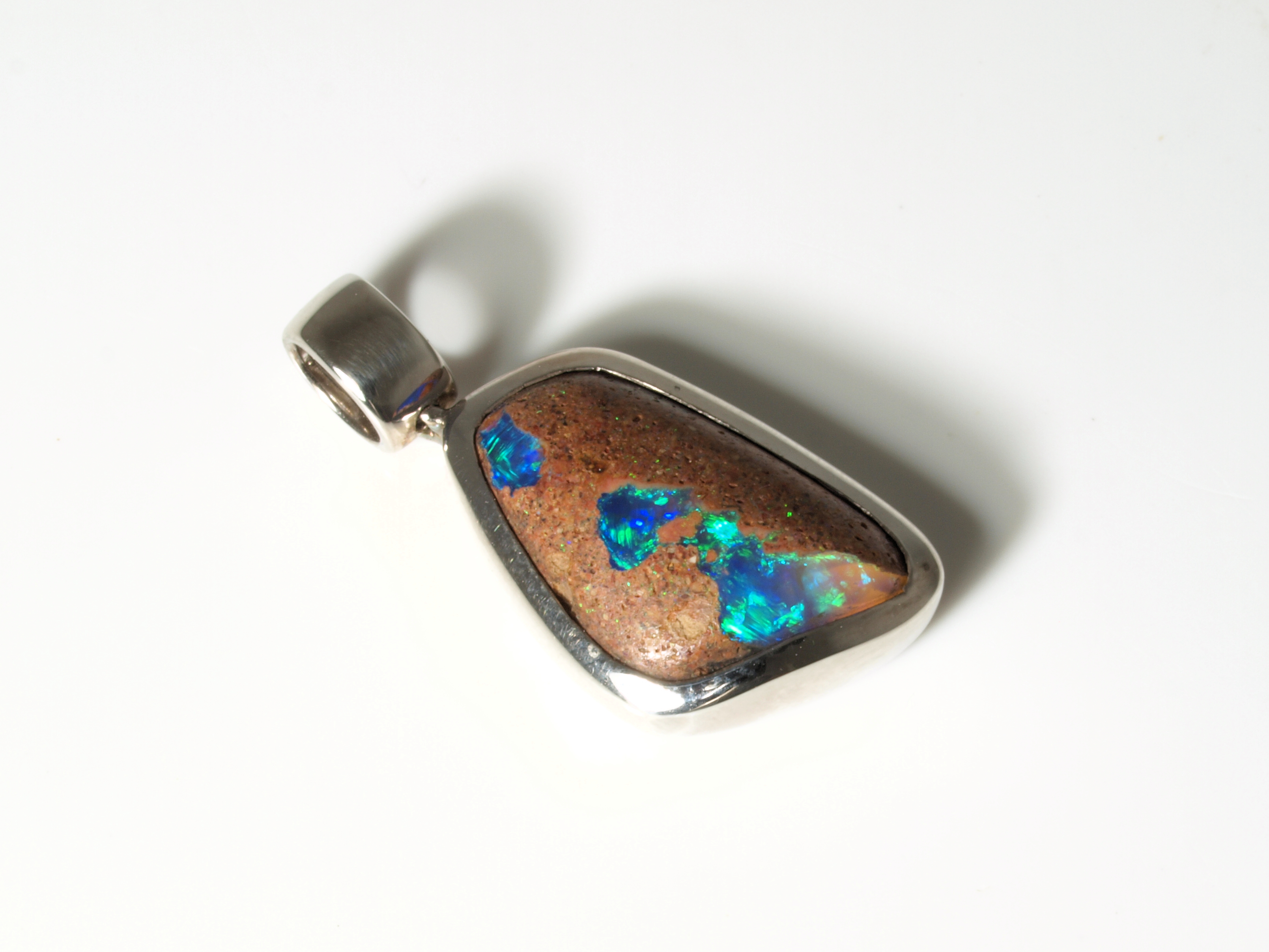 Custom silver necklace pendant showcasing a natural Australian boulder opal